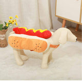 Plush toy shaped like a hot dog on a white surface with a neutral background