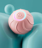 Automatic USB rechargeable kitten toy in pink bouncing near a sofa