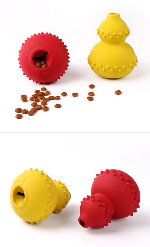 Two red and yellow textured dog toys with scattered kibble on a white background