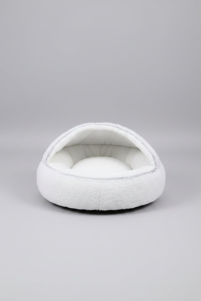 Anxious dog relaxing comfortably inside the orthopedic round plush bed.