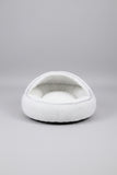 Anxious dog relaxing comfortably inside the orthopedic round plush bed.