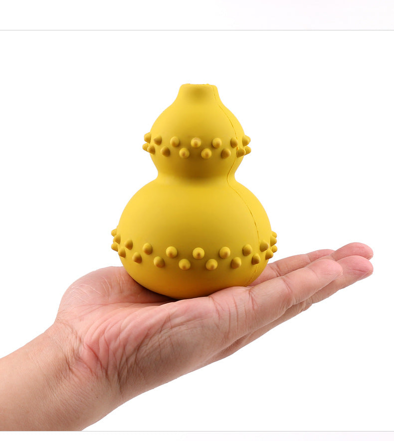 Yellow textured object held in a hand against a white background