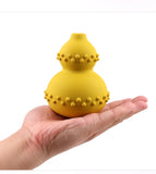 Yellow textured object held in a hand against a white background