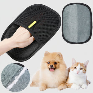 Dog owner gently petting a Golden Retriever using the black pet hair remover glove.