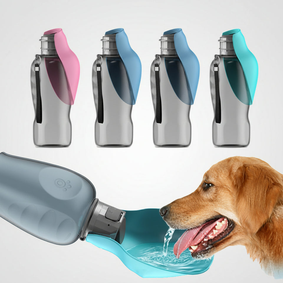Portable 27oz dog water bottle with wrist strap held during an outdoor hike