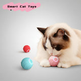 Smart interactive rolling cat ball in blue rolling across hardwood floor